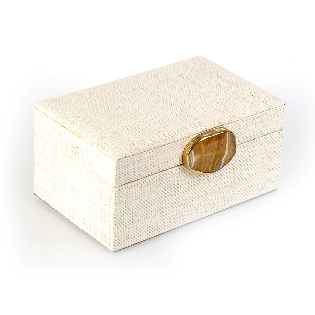 Karuna Raffia Jewelry Box, handcrafted from 100% natural raffia with a polished agate stone accent and hand-tooled brass detailing. Elegant, eco-friendly storage for jewelry and keepsakes.