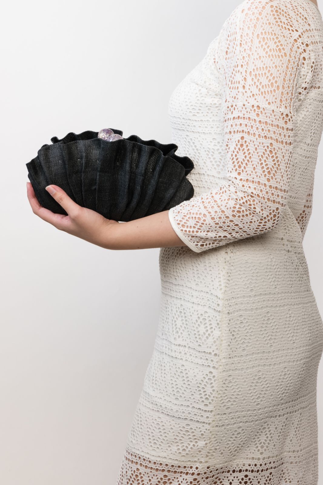 Handcrafted Josephine Clamshell Clutch made from T'boli tribe tinalak fabric, featuring shell-encrusted ball accents. A sustainable, elegant accessory for weddings, evening events, and gifts.