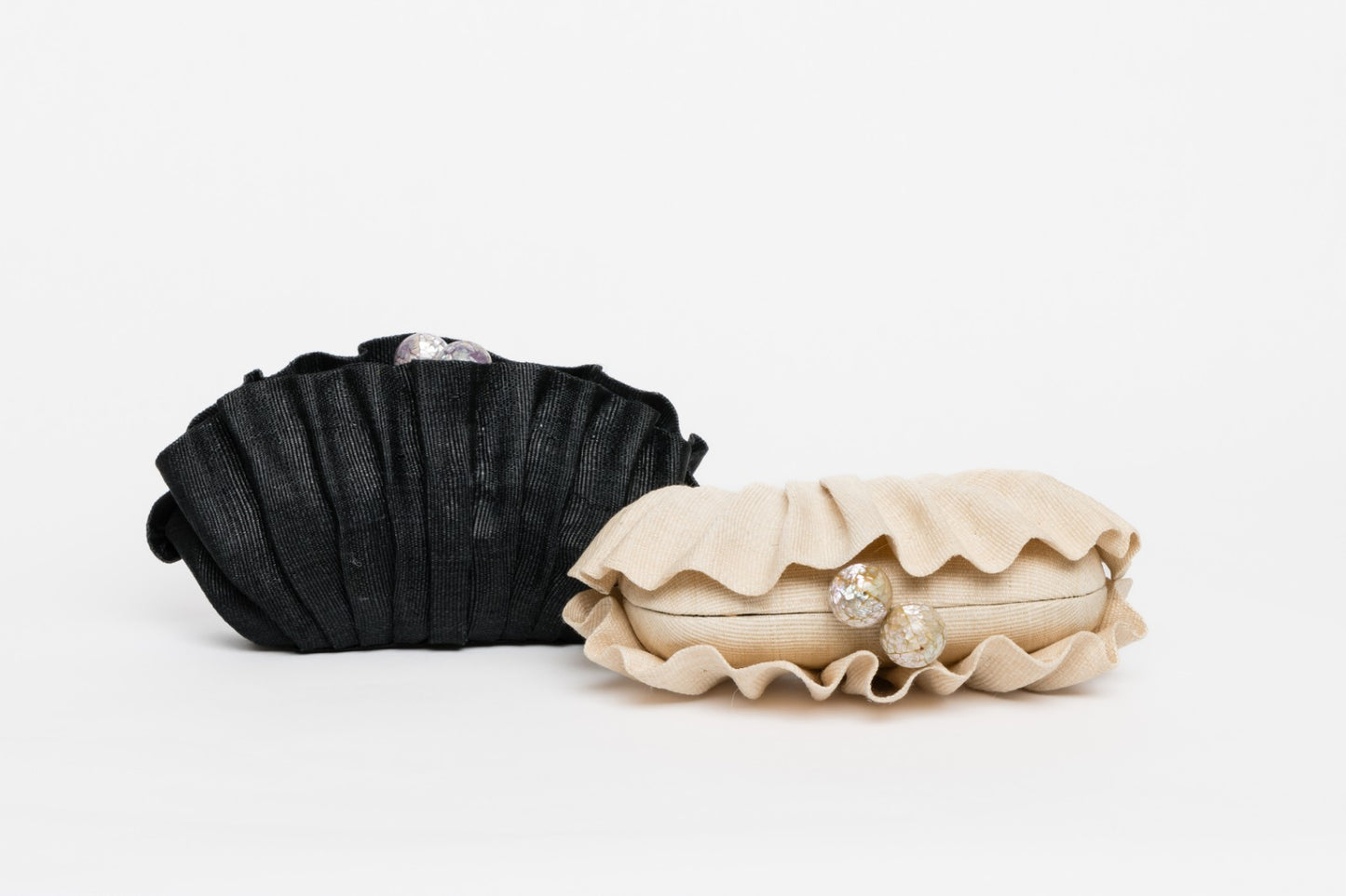 Handcrafted Josephine Clamshell Clutch made from T'boli tribe tinalak fabric, featuring shell-encrusted ball accents. A sustainable, elegant accessory for weddings, evening events, and gifts.