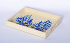 Elevate your home decor with Penelope Coral Blue Embroidered Trays made from eco-friendly raffia. Featuring elegant embroidery, these versatile trays serve as both functional and stylish accents for organizing or serving.