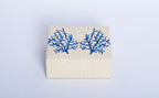 Store your jewelry in style with the Penelope Coral Blue Embroidery Jewelry Box. Made from eco-friendly materials and featuring intricate embroidery, this sustainable box combines function and elegance for your vanity or dresser.
