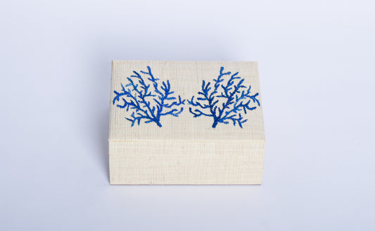 Store your jewelry in style with the Penelope Coral Blue Embroidery Jewelry Box. Made from eco-friendly materials and featuring intricate embroidery, this sustainable box combines function and elegance for your vanity or dresser.