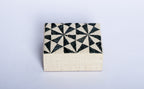 Store your jewelry in style with the Penelope Geometric Triangles Embroidery Jewelry Box. Made from eco-friendly materials and featuring intricate embroidery, this sustainable box combines function and elegance for your vanity or dresser.