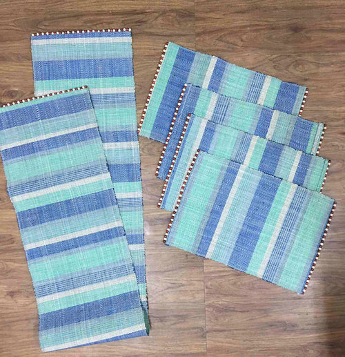 Abi Table Runner and Placemat Set of 4 in Ocean, handcrafted from 100% natural plant fiber, featuring a sustainable and elegant design.