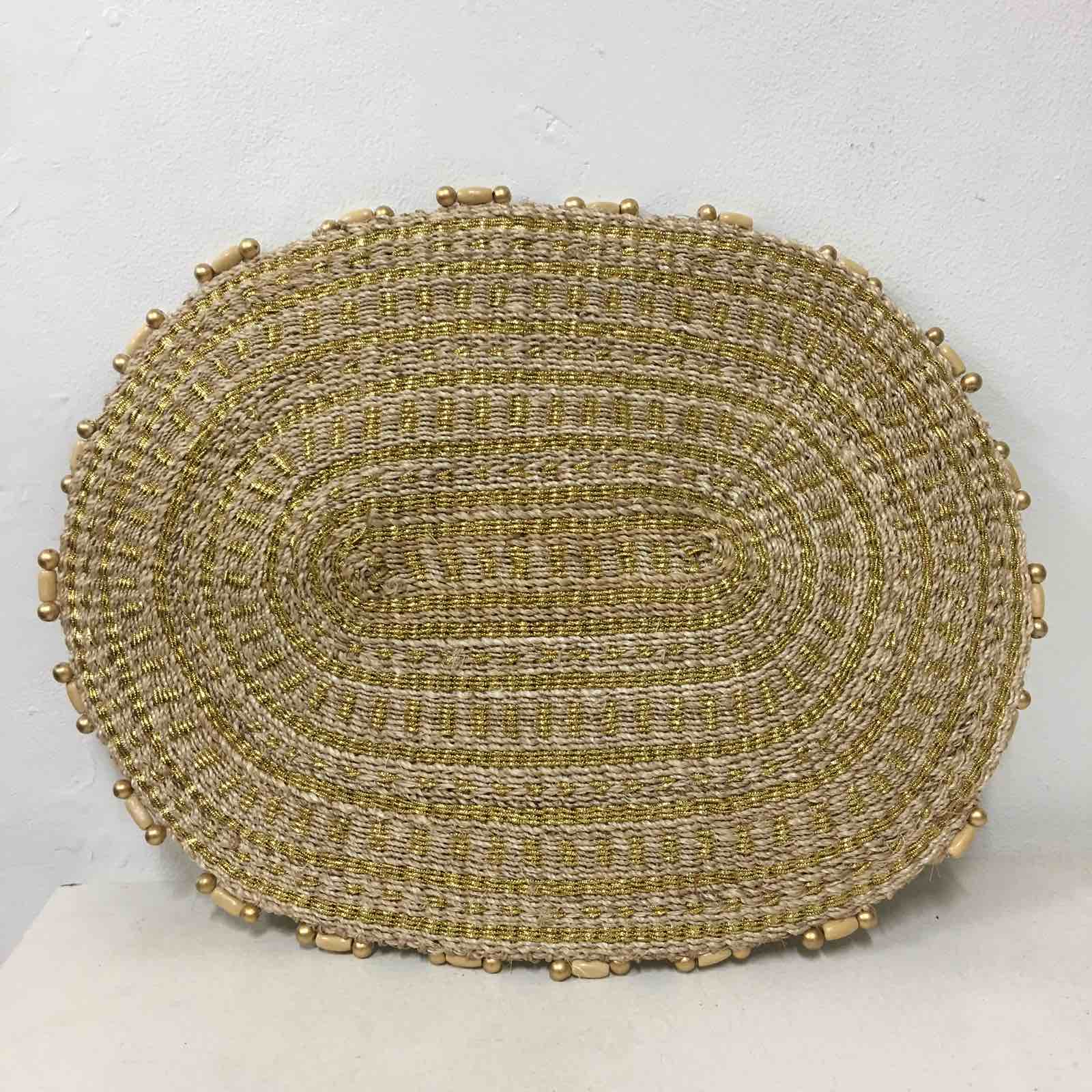 Arah Trivet Oval Plant Mat made from 100% natural plant fiber, perfect for dining, trivet use, or as a plant mat, with a gold cord accent.