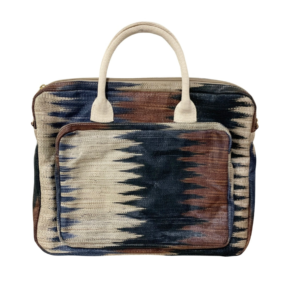 Deidre Brown Zigzag T'nalak Laptop Bag made from traditional T'nalak fabric, handwoven by the Tboli tribe in Mindanao using sustainable abaca plant fiber. This eco-friendly laptop bag accommodates devices up to 14 inches, blending heritage and modern utility with adjustable cotton straps. Durable 50% polyester and 50% cotton body. Spot clean for best care.