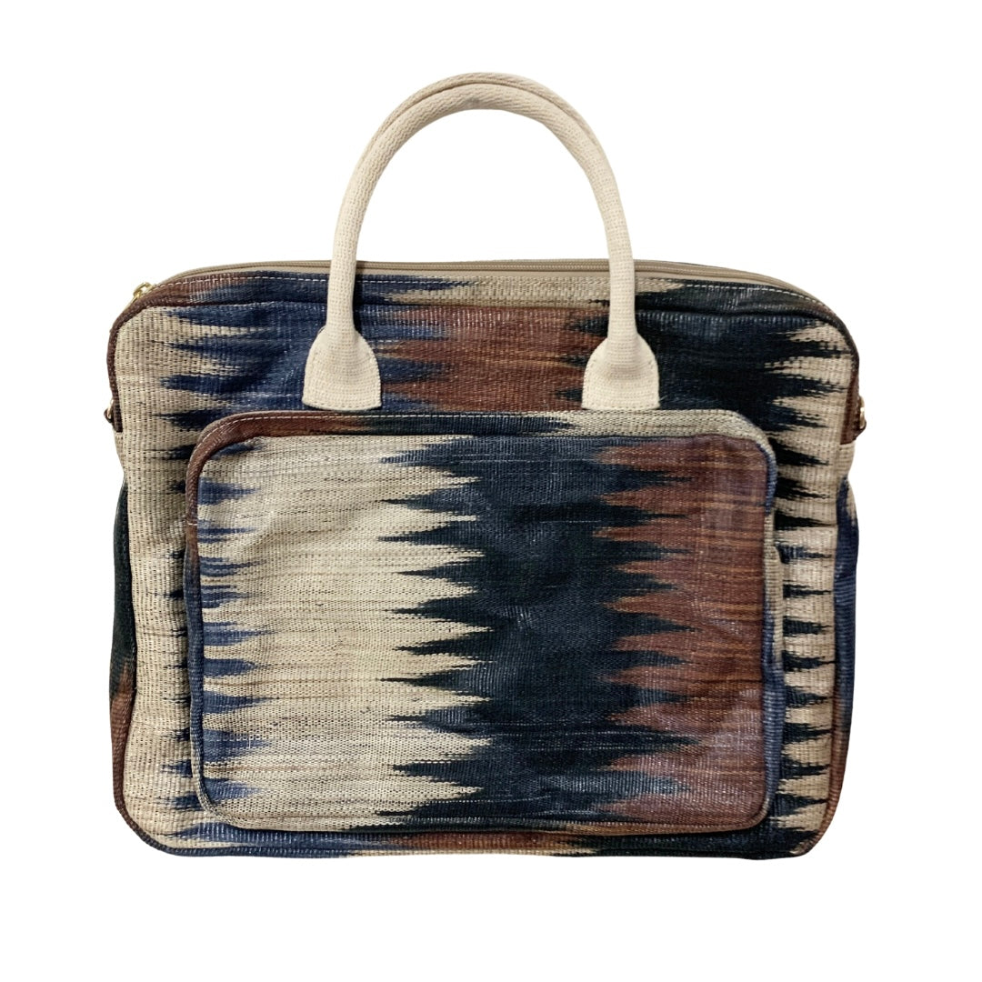 Deidre Brown Zigzag T'nalak Laptop Bag made from traditional T'nalak fabric, handwoven by the Tboli tribe in Mindanao using sustainable abaca plant fiber. This eco-friendly laptop bag accommodates devices up to 14 inches, blending heritage and modern utility with adjustable cotton straps. Durable 50% polyester and 50% cotton body. Spot clean for best care.
