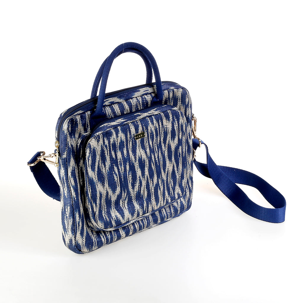 Deidre T'nalak Laptop Bag made from traditional T'nalak fabric, handwoven by the Tboli tribe in Mindanao using sustainable abaca plant fiber. This eco-friendly laptop bag accommodates devices up to 14 inches, blending heritage and modern utility with adjustable cotton straps. Durable 50% polyester and 50% cotton body. Spot clean for best care.