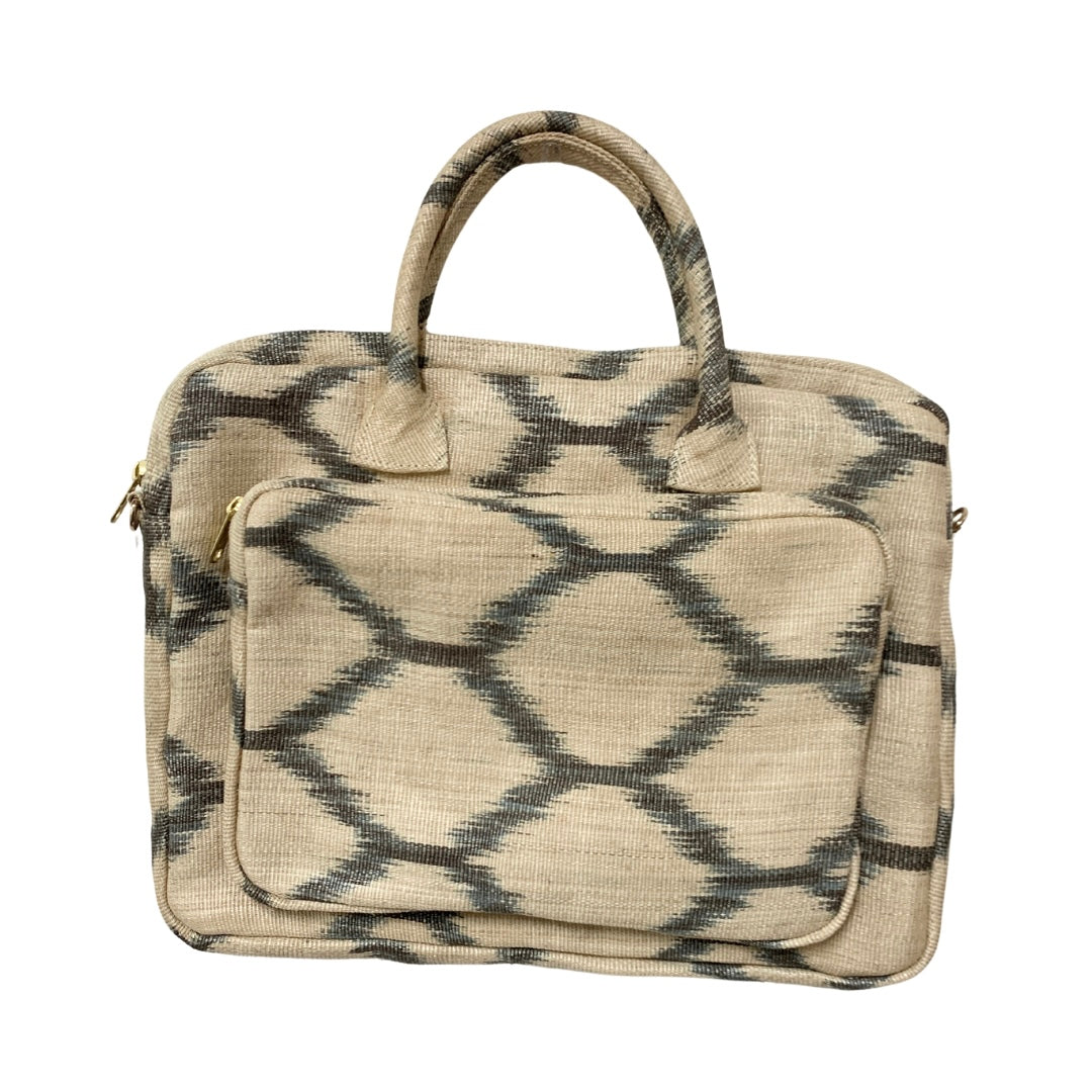 Deidre White Turtle T'nalak Laptop Bag made from traditional T'nalak fabric, handwoven by the Tboli tribe in Mindanao using sustainable abaca plant fiber. This eco-friendly laptop bag accommodates devices up to 14 inches, blending heritage and modern utility with adjustable cotton straps. Durable 50% polyester and 50% cotton body. Spot clean for best care.