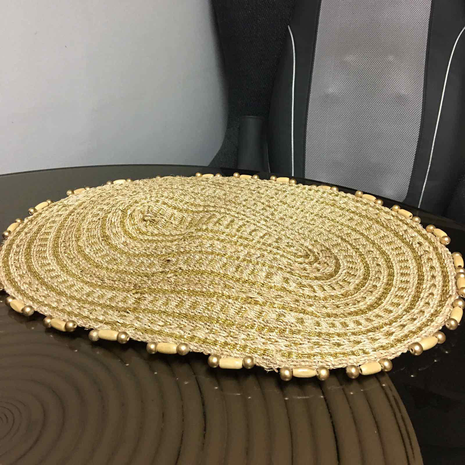 Arah Trivet Oval Plant Mat made from 100% natural plant fiber, perfect for dining, trivet use, or as a plant mat, with a gold cord accent.