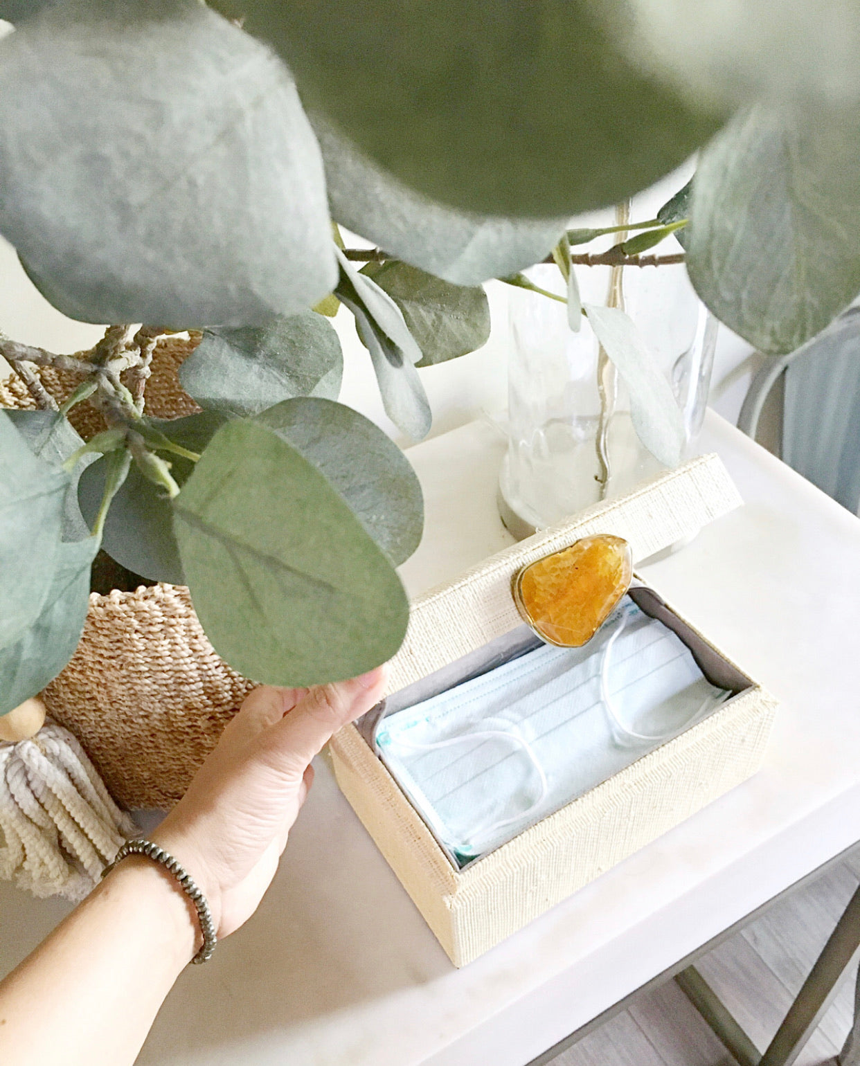 Karuna Raffia Jewelry Box, handcrafted from 100% natural raffia with a polished agate stone accent and hand-tooled brass detailing. Elegant, eco-friendly storage for jewelry and keepsakes.