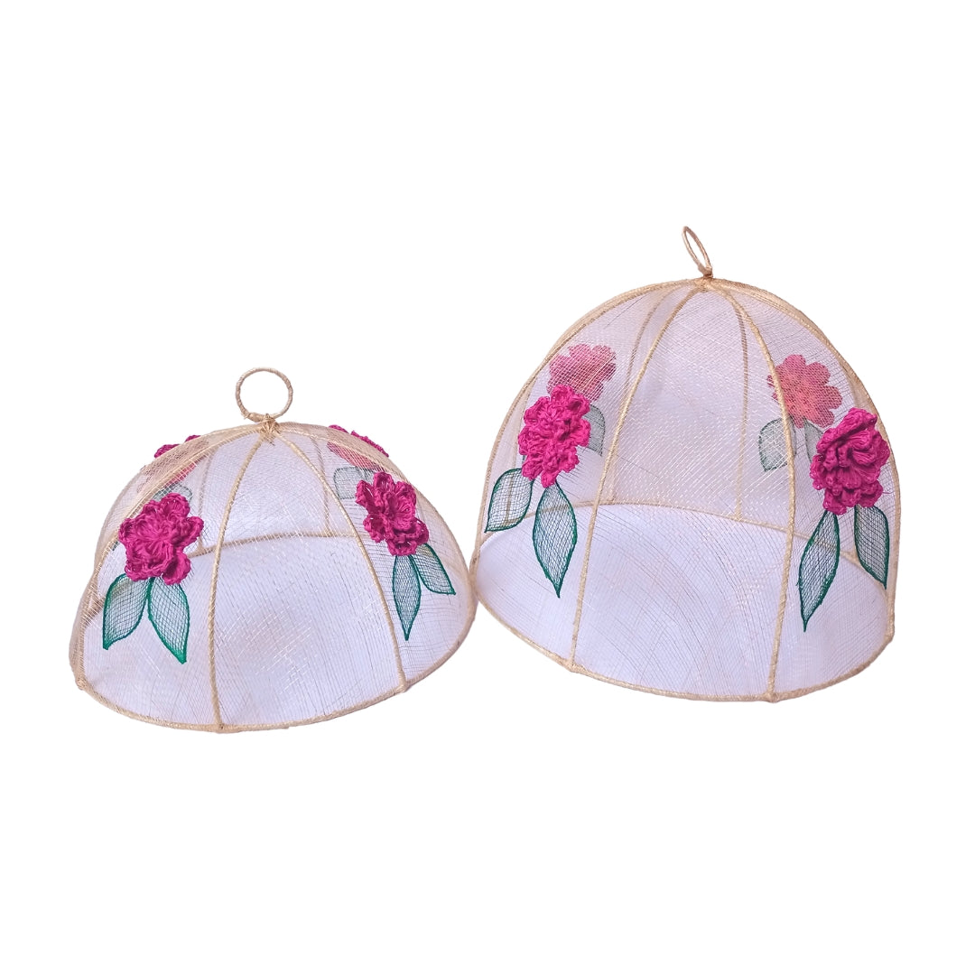 Julieta Woven Fuchsia Food Covers Set of two sizes, crafted from 100% natural plant fibers with vibrant embroidered designs. Eco-friendly, stylish covers for indoor and outdoor dining.