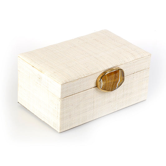 Karuna Raffia Jewelry Box, handcrafted from 100% natural raffia with a polished agate stone accent and hand-tooled brass detailing. Elegant, eco-friendly storage for jewelry and keepsakes.