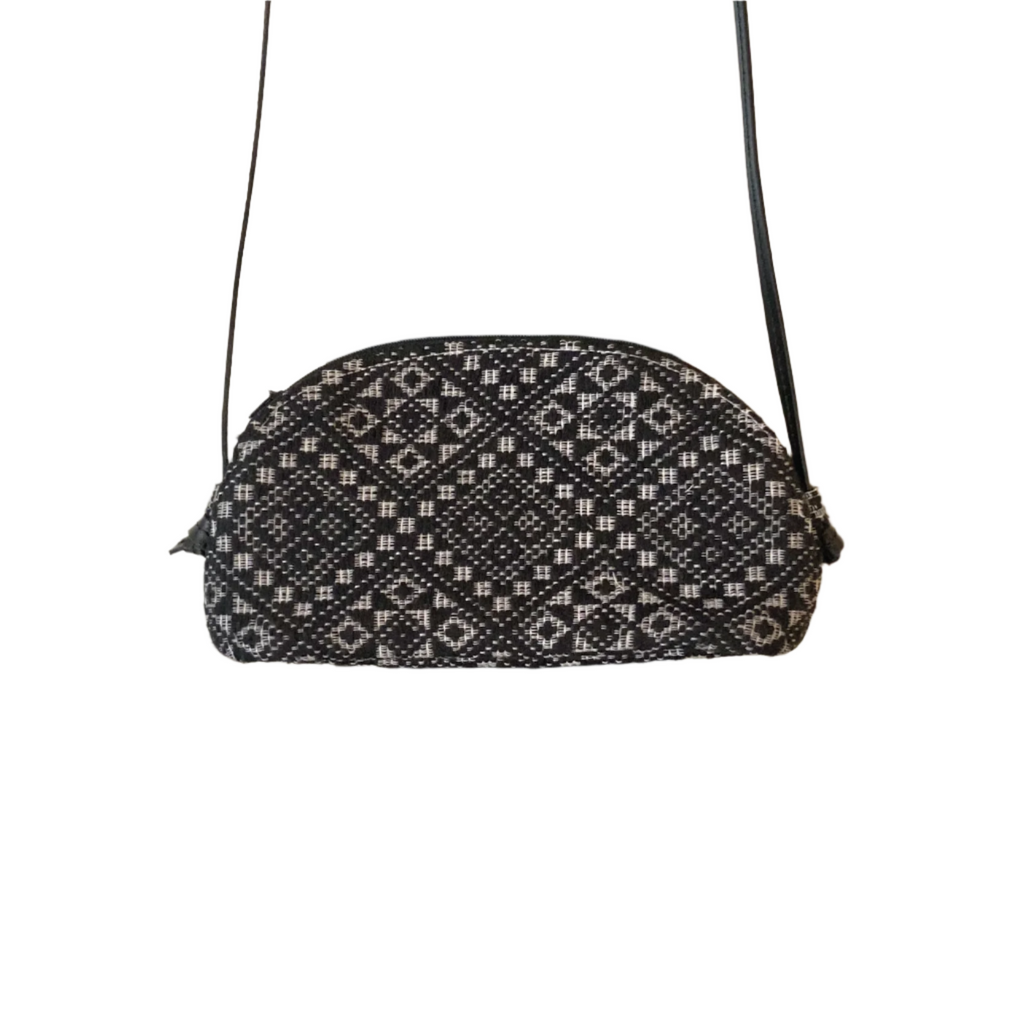 Katrina Abel Sling Bag Black Diamond, crafted from traditional Pinilian Inabel fabric, showcasing vibrant geometric motifs. Handwoven in the Ilocos region, with leather straps for modern functionality and artisan craftsmanship
