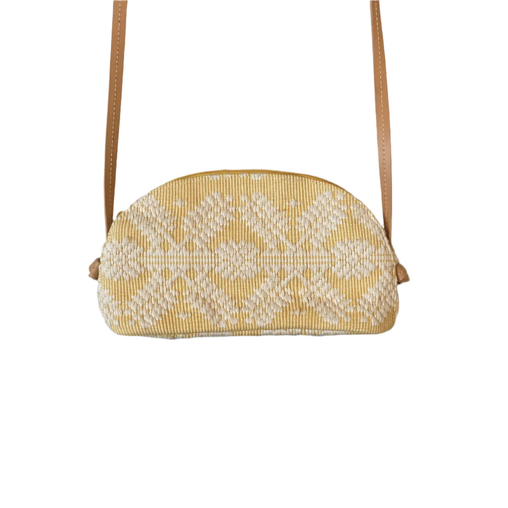 Katrina Abel Sling Bag Yellow Snowflake, crafted from traditional Pinilian Inabel fabric, showcasing vibrant geometric motifs. Handwoven in the Ilocos region, with leather straps for modern functionality and artisan craftsmanship