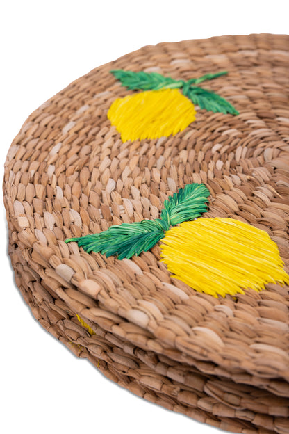 Lorenzo Lemons Seagrass Round Placemats set of 6, handcrafted from 100% natural plant fibers with embroidered designs of lemons and tropical leaves. Eco-friendly, durable, and stylish, perfect for enhancing your dining table decor.