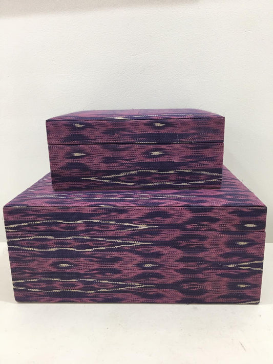 Mia Storage Boxes Set of 2 - Peacock, featuring handwoven tinalak fabric in vibrant colors, displayed on a wooden shelf with organized essentials.