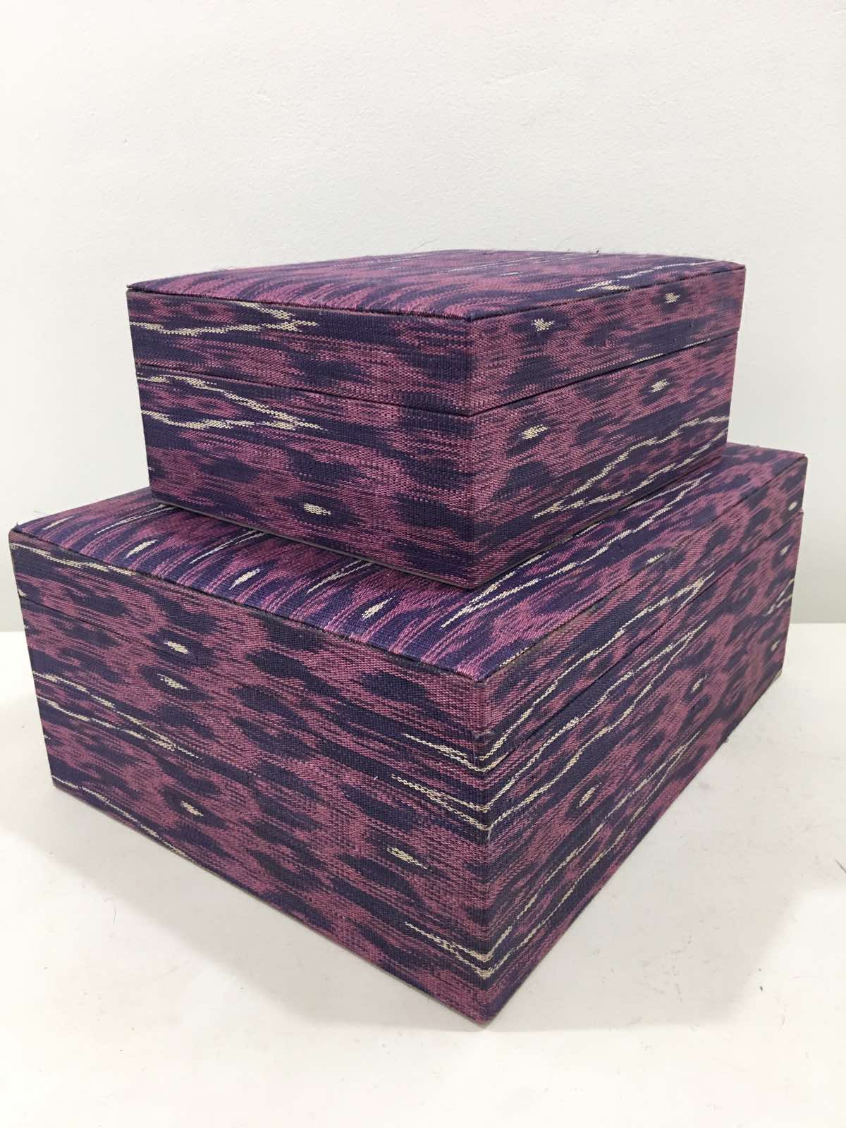 Mia Storage Boxes Set of 2 - Peacock, featuring handwoven tinalak fabric in vibrant colors, displayed on a wooden shelf with organized essentials.