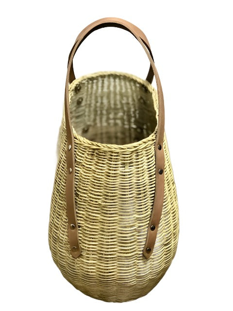 Cedric Wicker Carry All Basket, made from 100% natural rattan with luxurious 100% leather handles, is a multi-purpose basket designed for stylish organization. Perfect for use as a catch-all at your entryway, it holds essentials like caps, gloves, and sunglasses. Ideal for carrying fresh fruits and vegetables from the market, this chic and durable basket also makes picnic outings effortless with ample space for food and drink. Ditch conventional bags by using it as a unique gym or yoga bag, combining fashio