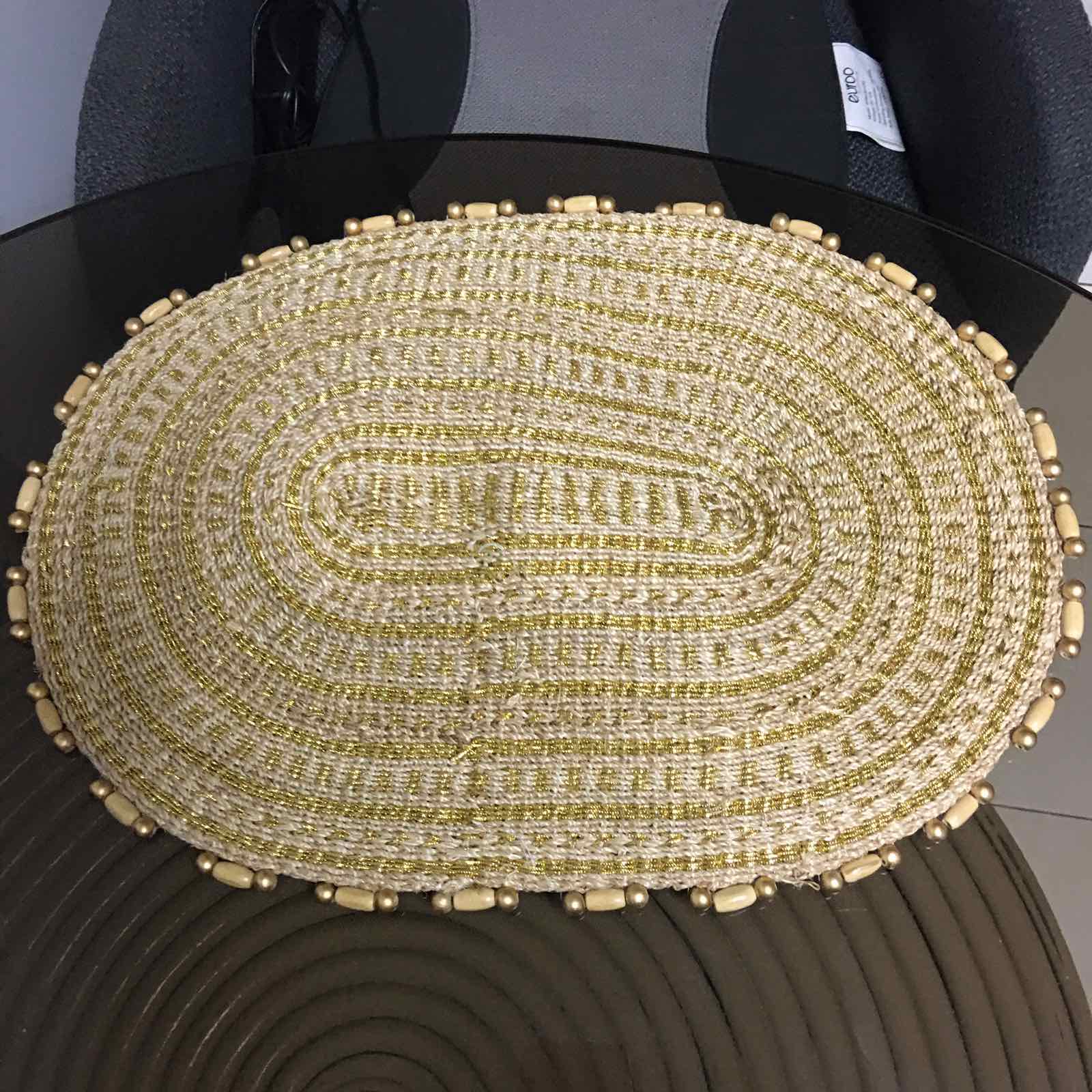 Arah Trivet Oval Plant Mat made from 100% natural plant fiber, perfect for dining, trivet use, or as a plant mat, with a gold cord accent.