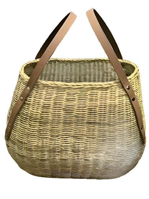 Cedric Wicker Carry All Basket, made from 100% natural rattan with luxurious 100% leather handles, is a multi-purpose basket designed for stylish organization. Perfect for use as a catch-all at your entryway, it holds essentials like caps, gloves, and sunglasses. Ideal for carrying fresh fruits and vegetables from the market, this chic and durable basket also makes picnic outings effortless with ample space for food and drink. Ditch conventional bags by using it as a unique gym or yoga bag, combining fashio